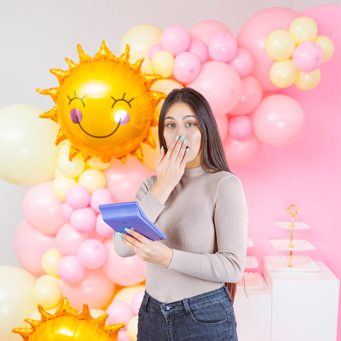 lady with calculator in front of balloon garland