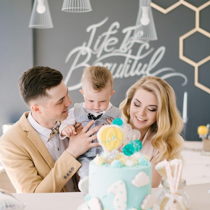 family celebrating first birthday party